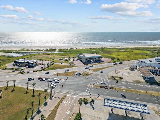 birds eye view of property featuring a beach view and a water view