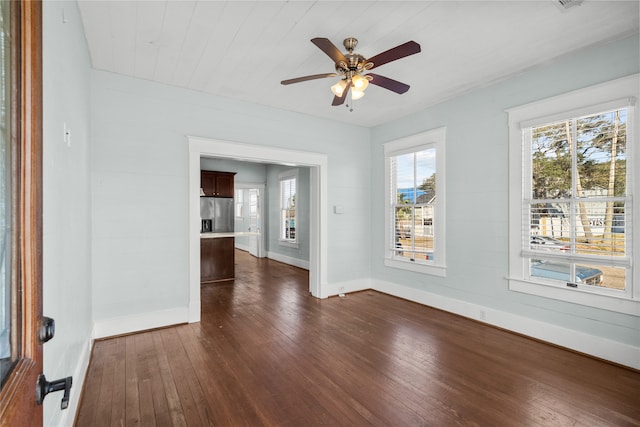 unfurnished room featuring dark wood-type flooring and ceiling fan