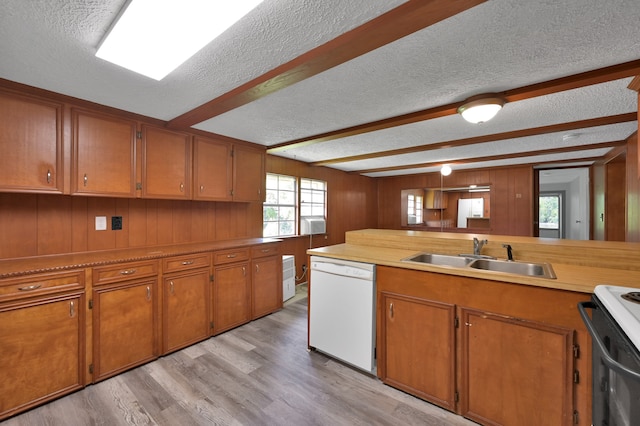 kitchen featuring sink, white dishwasher, a textured ceiling, and light wood-type flooring