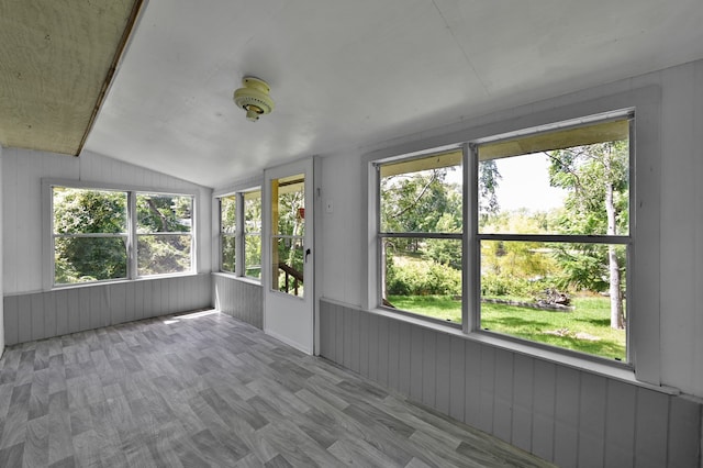 unfurnished sunroom with lofted ceiling