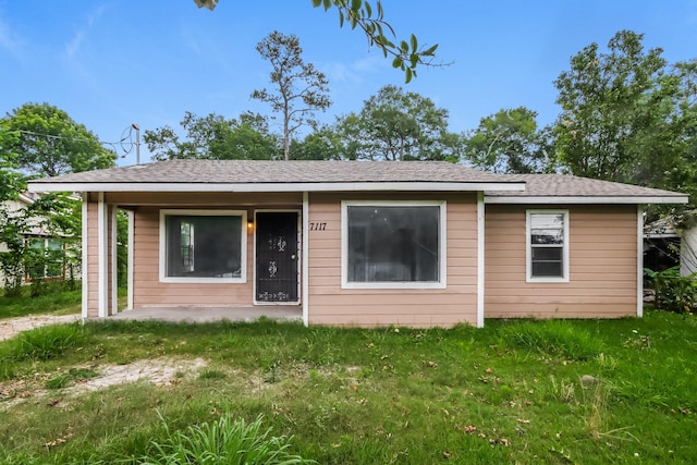 rear view of house with a yard