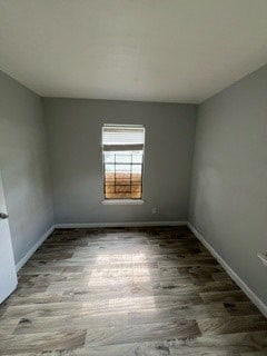 spare room with hardwood / wood-style flooring