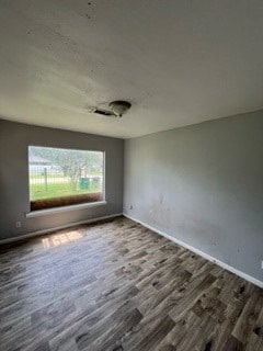 unfurnished room featuring dark hardwood / wood-style floors