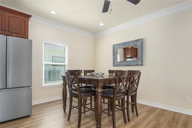 dining space with light hardwood / wood-style floors, ornamental molding, and ceiling fan