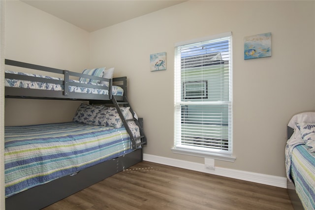 bedroom with dark hardwood / wood-style floors