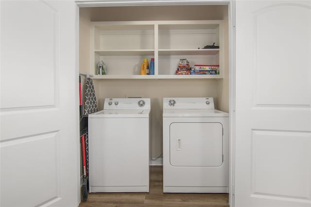 laundry area featuring washer and clothes dryer and hardwood / wood-style flooring