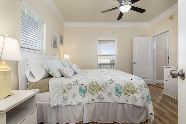 bedroom featuring ceiling fan, wood-type flooring, and ornamental molding