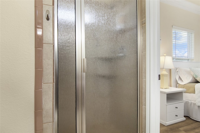 details featuring wood-type flooring and a shower with door