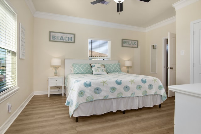 bedroom with hardwood / wood-style flooring, crown molding, and ceiling fan