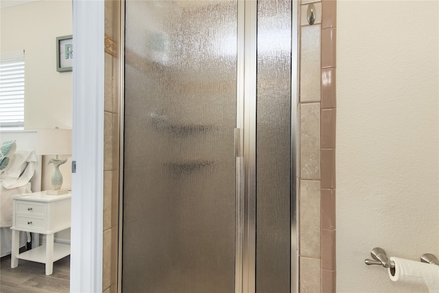 interior details featuring hardwood / wood-style flooring and walk in shower