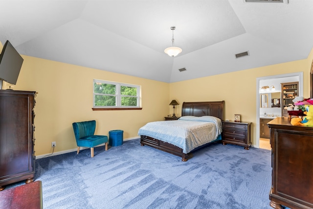 bedroom featuring connected bathroom, vaulted ceiling, and carpet