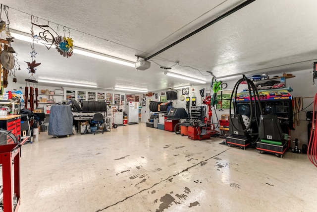 garage with white refrigerator and a garage door opener