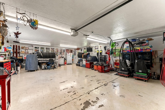 garage featuring a garage door opener and a workshop area