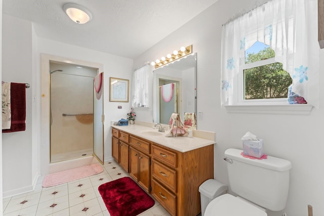 bathroom with toilet, a stall shower, baseboards, and vanity