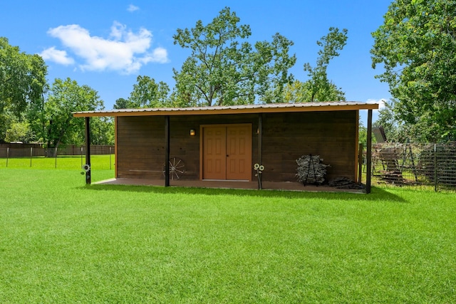 view of outbuilding with fence and an outbuilding