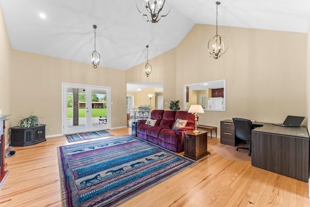 living room featuring french doors, an inviting chandelier, high vaulted ceiling, light wood-type flooring, and baseboards