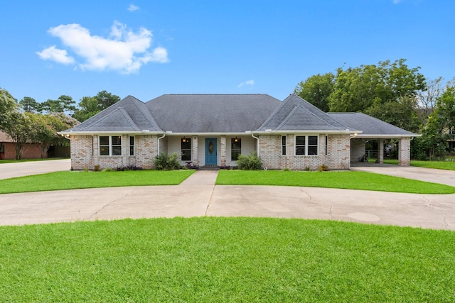 ranch-style house with driveway, a carport, a front yard, and brick siding