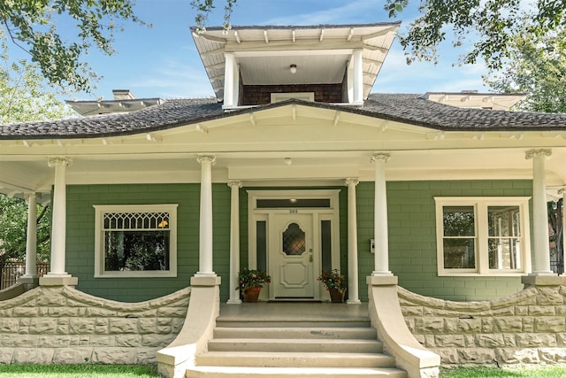 entrance to property featuring covered porch