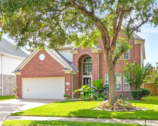 view of property with a garage and a front yard