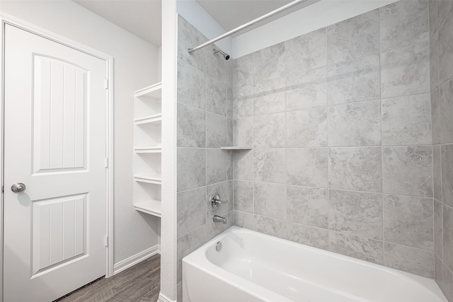 bathroom featuring tiled shower / bath and wood-type flooring