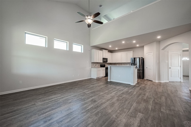 kitchen with ceiling fan, hardwood / wood-style flooring, black appliances, and high vaulted ceiling