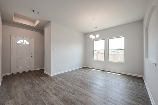 entryway featuring plenty of natural light, dark hardwood / wood-style floors, and a notable chandelier