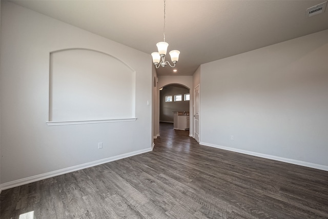 unfurnished room with hardwood / wood-style floors and a chandelier