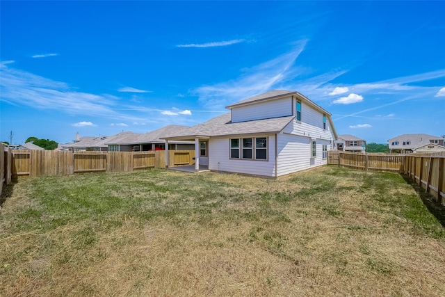 rear view of house featuring a patio area and a lawn