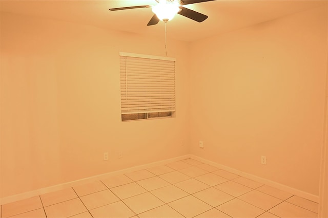 tiled spare room with ceiling fan