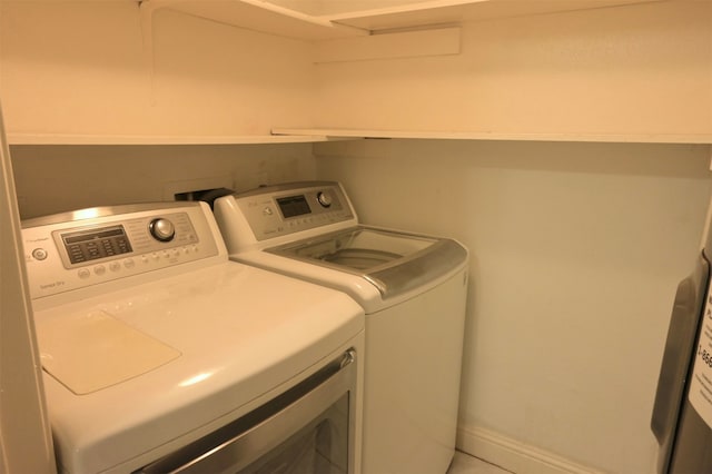 clothes washing area featuring washer and clothes dryer