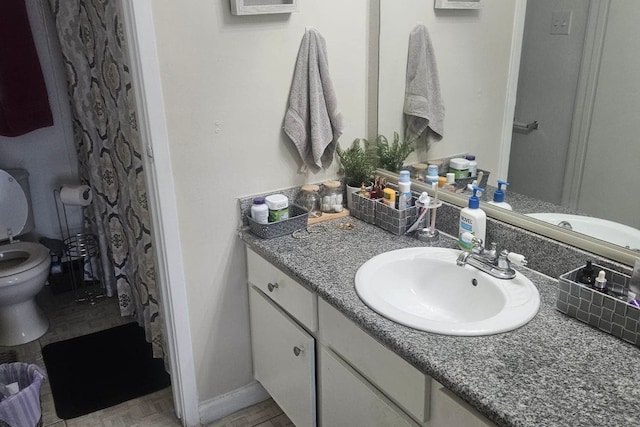 bathroom featuring tile patterned floors, vanity, and toilet