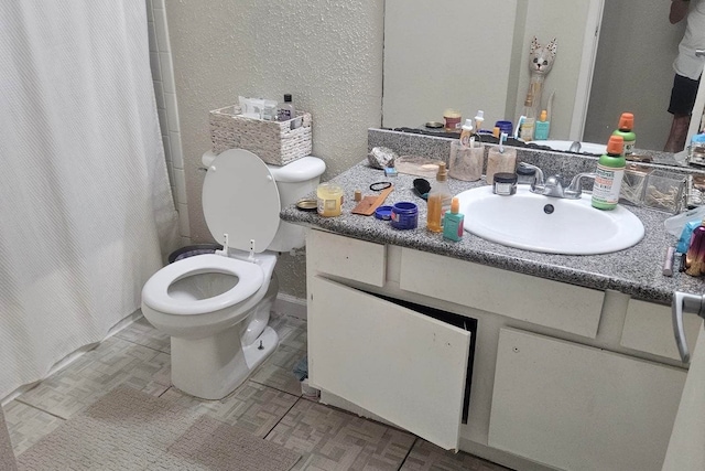 bathroom with tile patterned flooring, toilet, and vanity