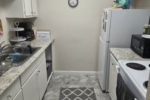 kitchen with sink, white cabinetry, light tile patterned floors, and white stove