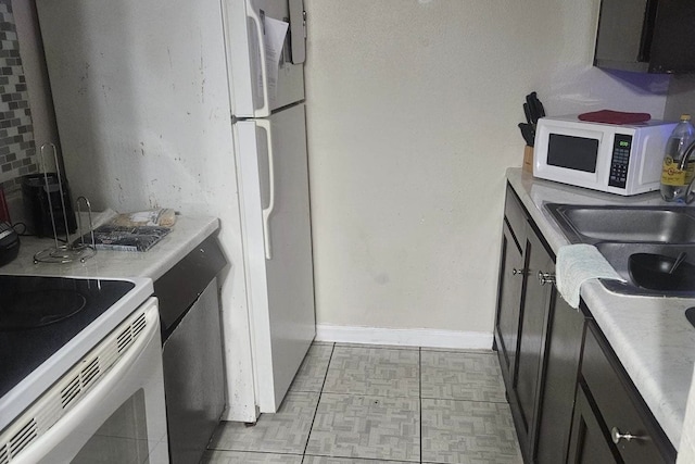 kitchen with light tile patterned flooring and white appliances