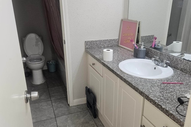 bathroom featuring tile patterned floors, toilet, and vanity