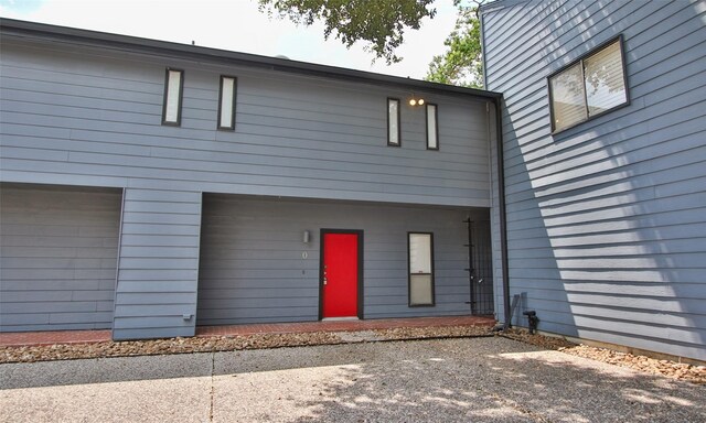 rear view of property with a garage