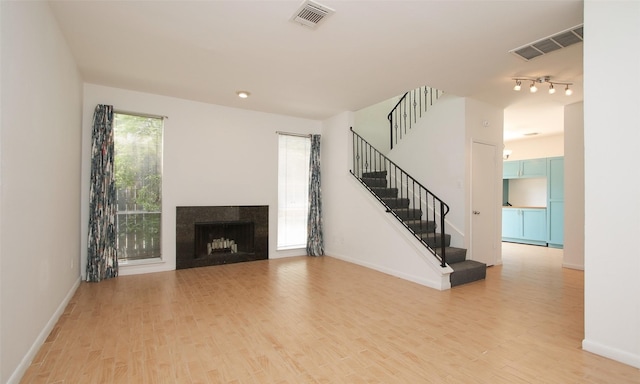 unfurnished living room featuring light hardwood / wood-style floors