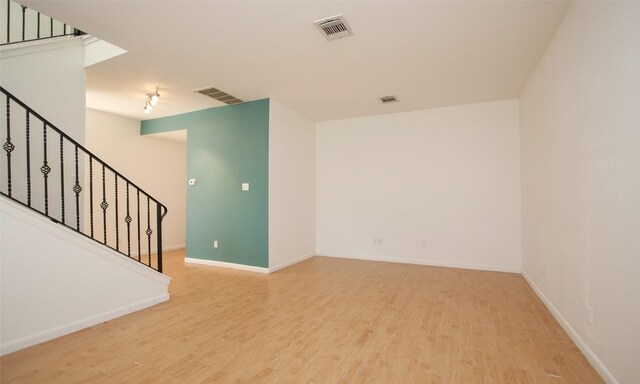 spare room featuring wood-type flooring