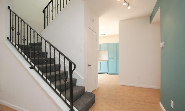 stairway featuring hardwood / wood-style flooring