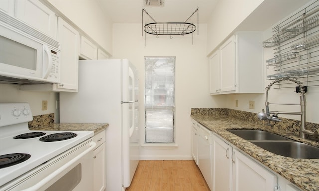 kitchen featuring white cabinets, white appliances, light hardwood / wood-style flooring, and sink