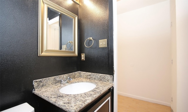 bathroom featuring hardwood / wood-style floors and vanity