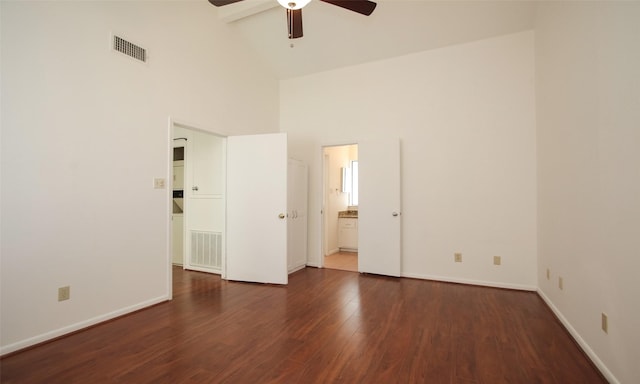 empty room with beam ceiling, ceiling fan, high vaulted ceiling, and dark hardwood / wood-style floors