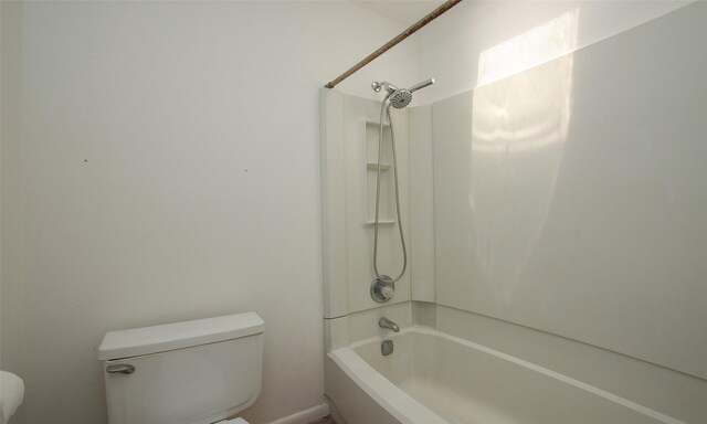 bathroom featuring shower / bath combination and toilet