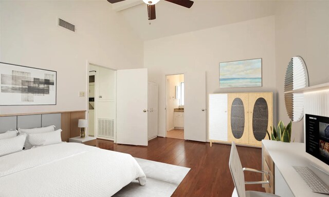 bedroom featuring ceiling fan, dark wood-type flooring, a high ceiling, ensuite bathroom, and a fireplace