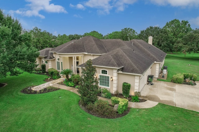 view of front of home with a front lawn and a garage