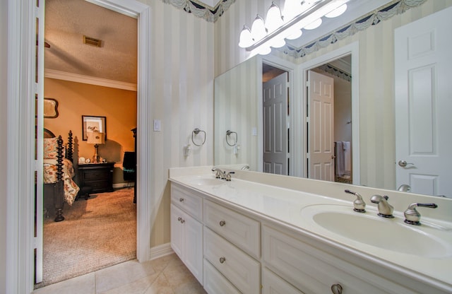 bathroom with vanity, a textured ceiling, tile patterned floors, and crown molding