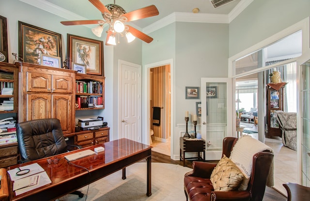 home office featuring crown molding, ceiling fan, and light wood-type flooring