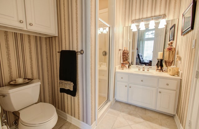 bathroom with tile patterned flooring, vanity, an enclosed shower, and toilet