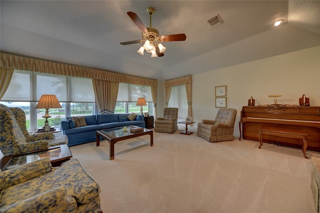 living room with lofted ceiling, light colored carpet, and ceiling fan