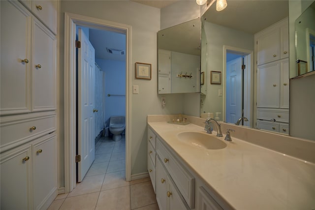 bathroom with vanity, toilet, and tile patterned flooring